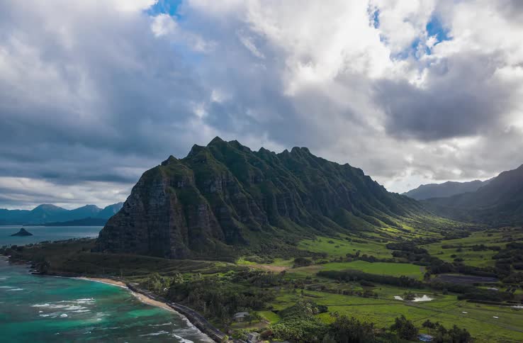 Turquoise ocean water washes onto a lush green island