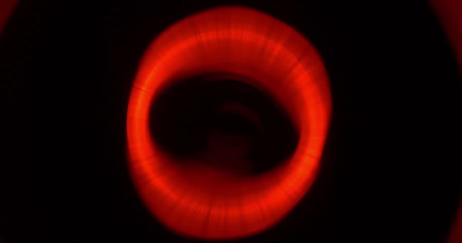 A red circle coming in and out of focus