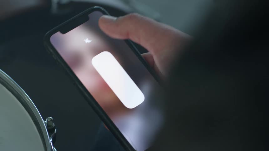 A person turning up the volume on a smartphone