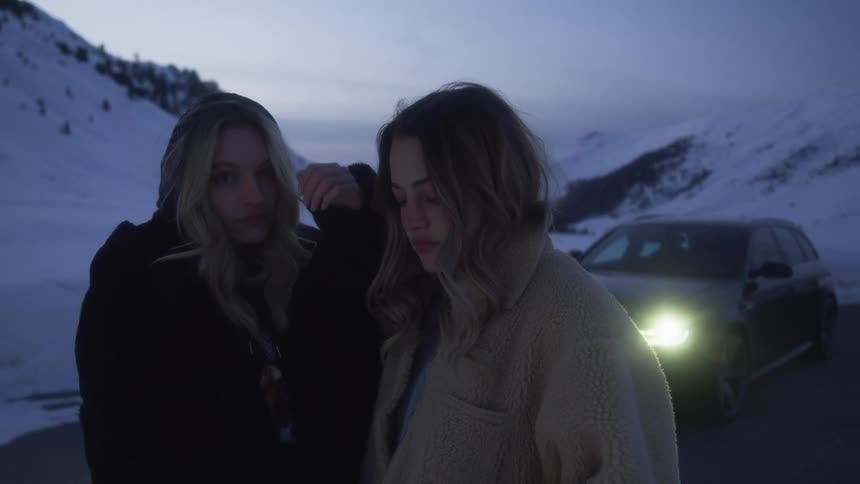 Two women that are standing outdoors next to each other