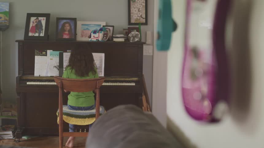 A girl playing a piano