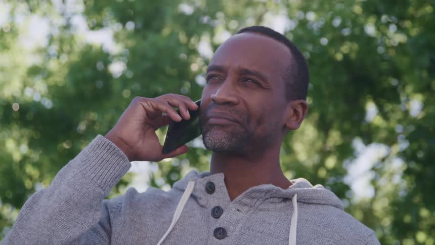 A man is using his cellphone outside