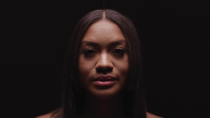 A black woman raises her head and looks straight ahead