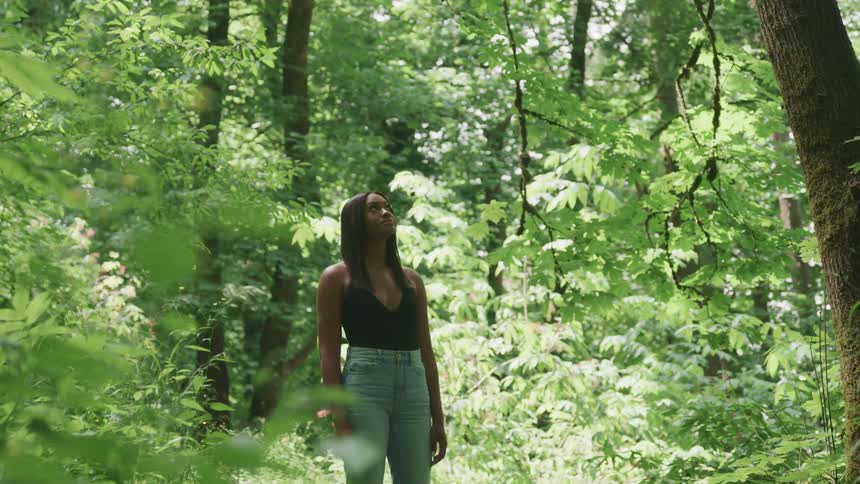 A woman standing in a forest
