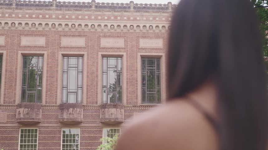 A woman that is looking at a building
