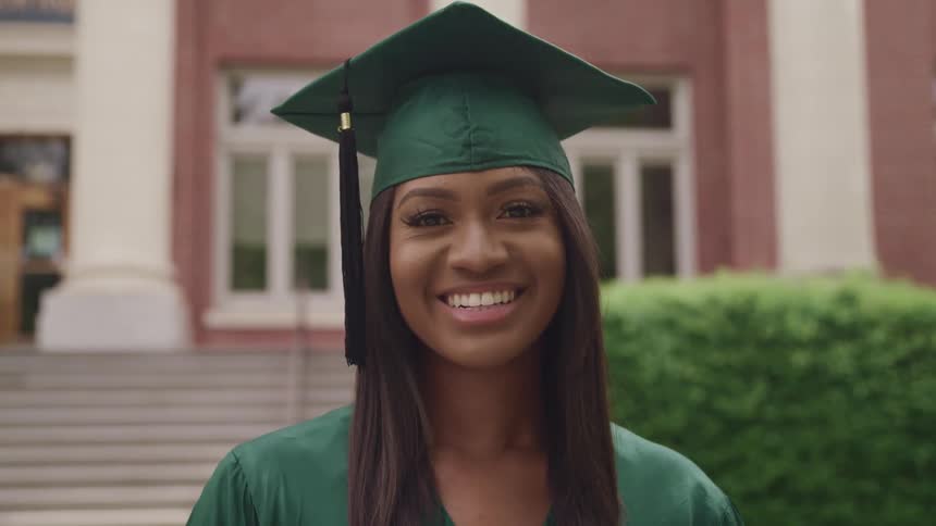 A portrait of a woman graduating outdoors
