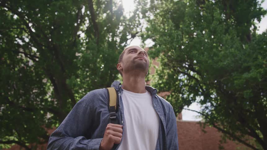 A man is looking around outside