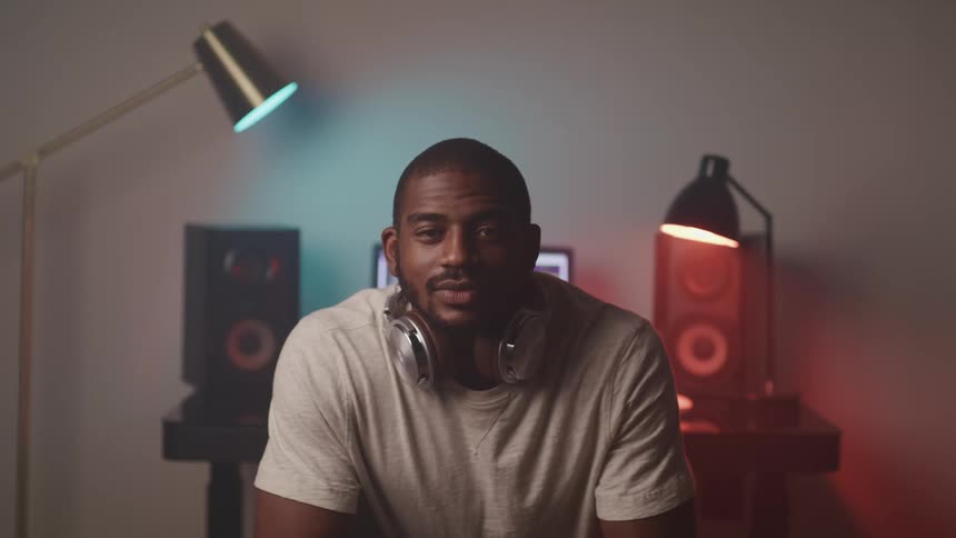 A portrait of a man that has headphones on