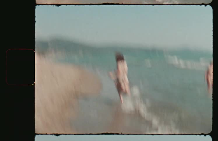 A woman in a sundress runs playfully on a sandy beach