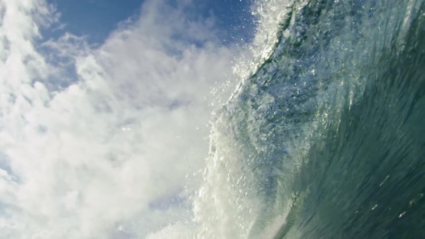 An ocean wave crashing down in the daytime