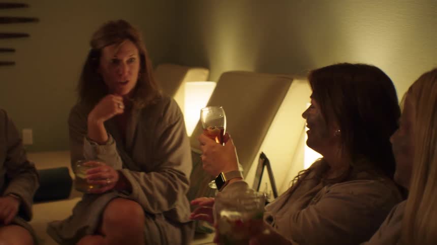 Group of women toast with drinks in spa