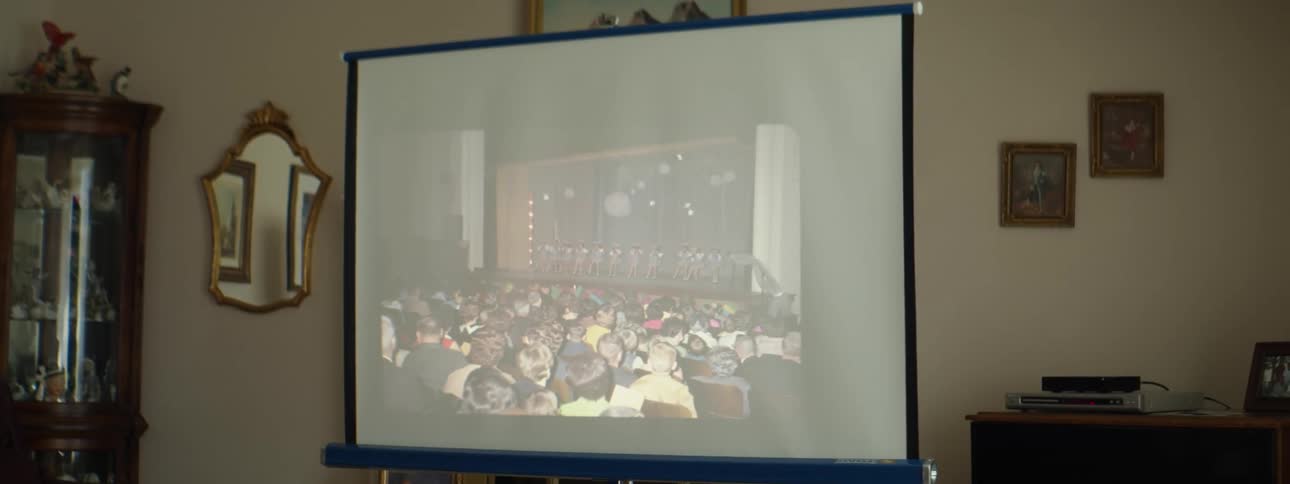 Slides projected on a screen in the wall at home
