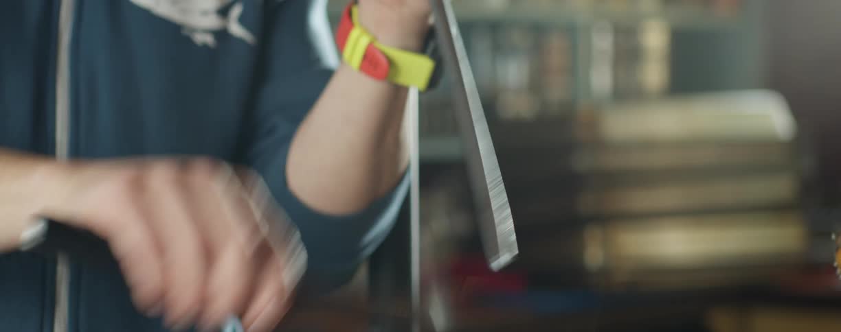 Man sharpening a knife by hand in the kitchen