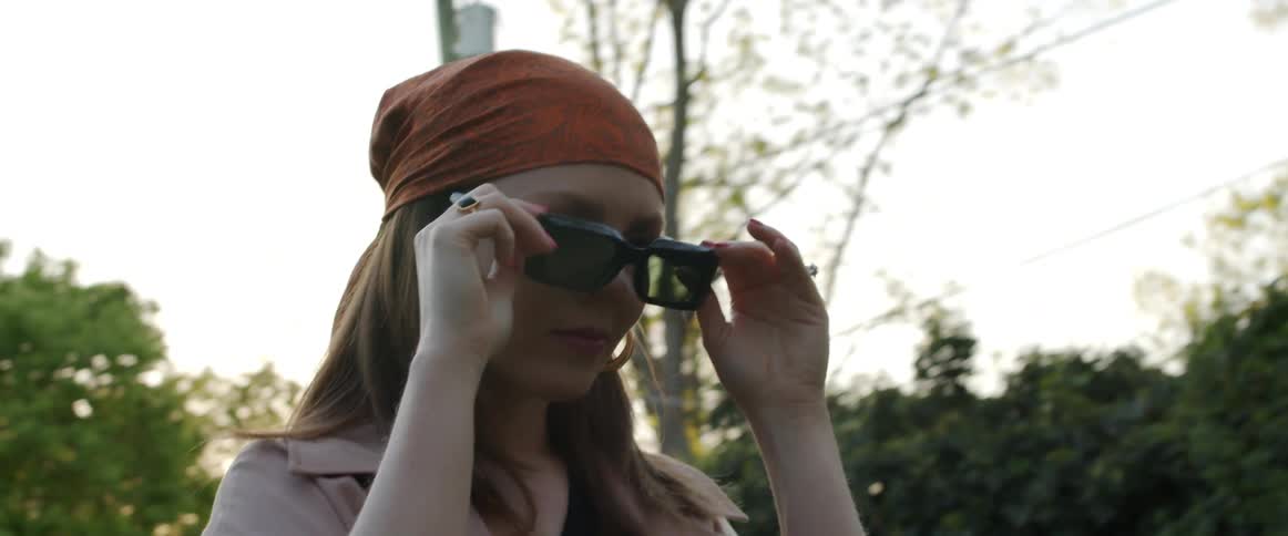 A woman taking off glasses