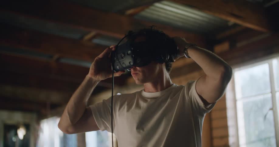 A man putting on a virtual reality headset