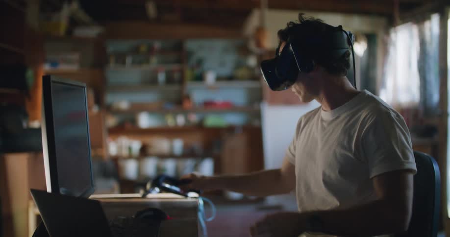 Man testing virtual reality goggles inside a workshop