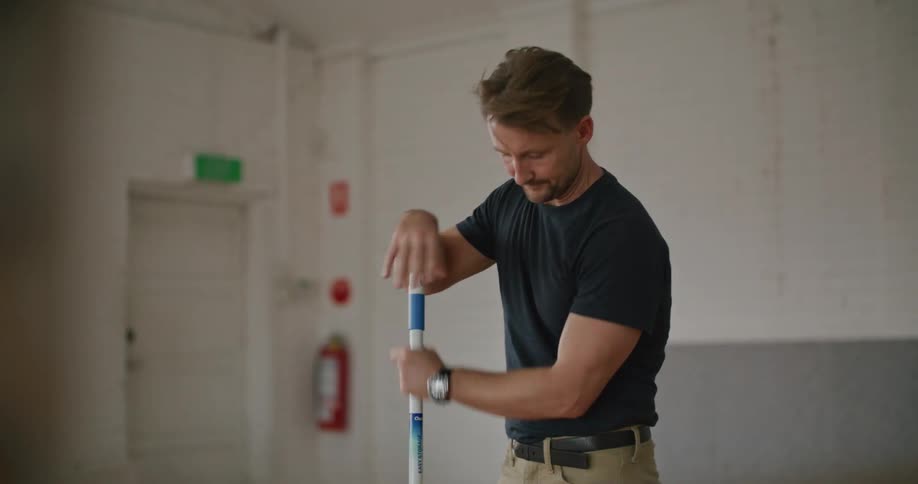 An employee mopping a floor