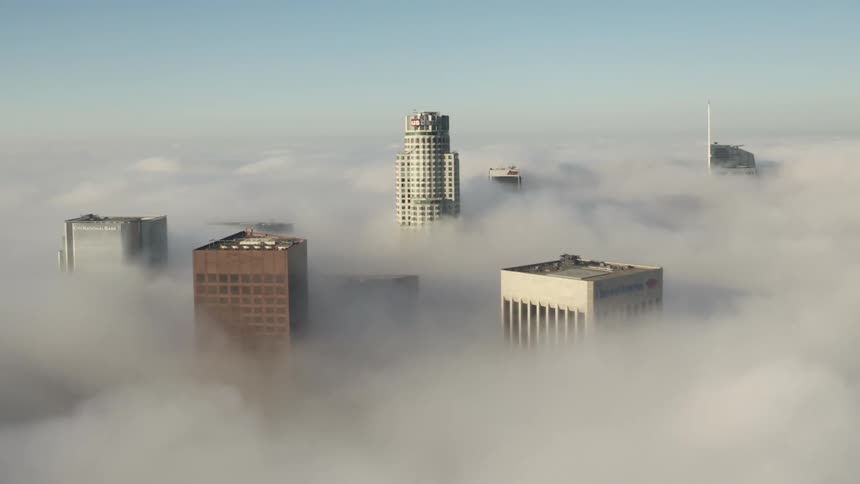 Skyscrapers towering over the cloud layer at daytime