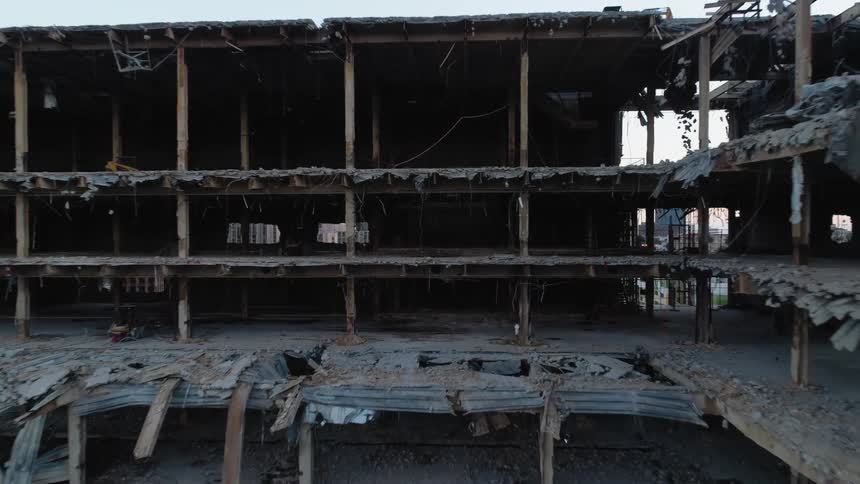An aerial view of a building mid demolition
