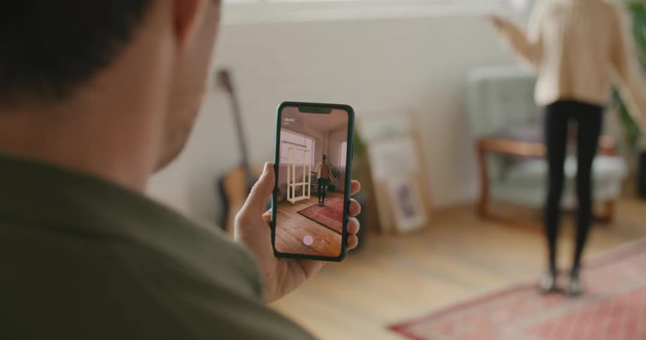A man using a smartphone in a room