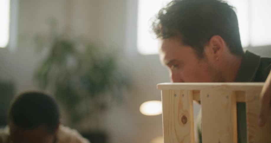 Young couple assembling furniture on the floor of the living room