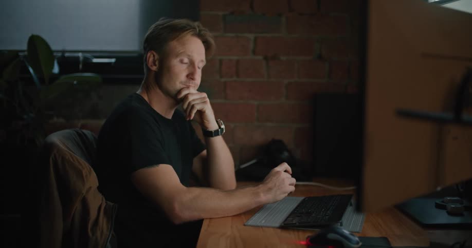 A man working in an office on a computer