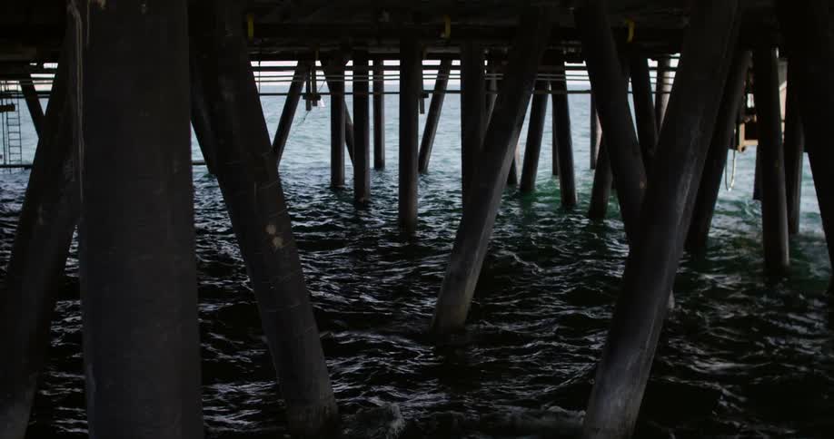 Gentle waves under a pier