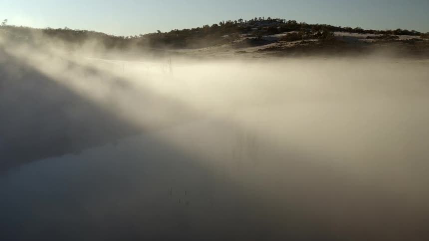 A view of smoke and clouds above an area