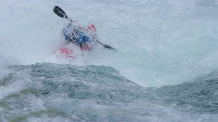The future is now when a man in a red whitewater kayak stylishly descends a waterfall in a crystal clear river