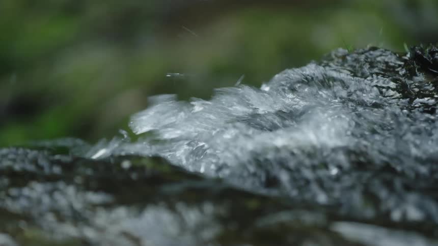 Static establishing shot of water cascading over a creek in this pleasing to the eye shot