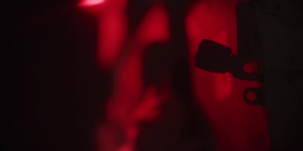 The silhouette of a hand flipping levers up with a red glow