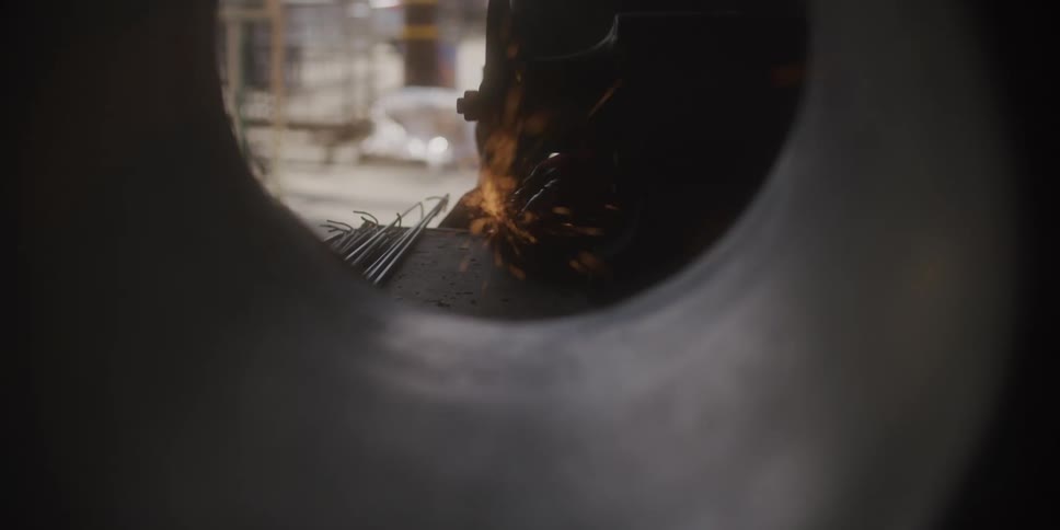 Sparks flying around metal in a workshop