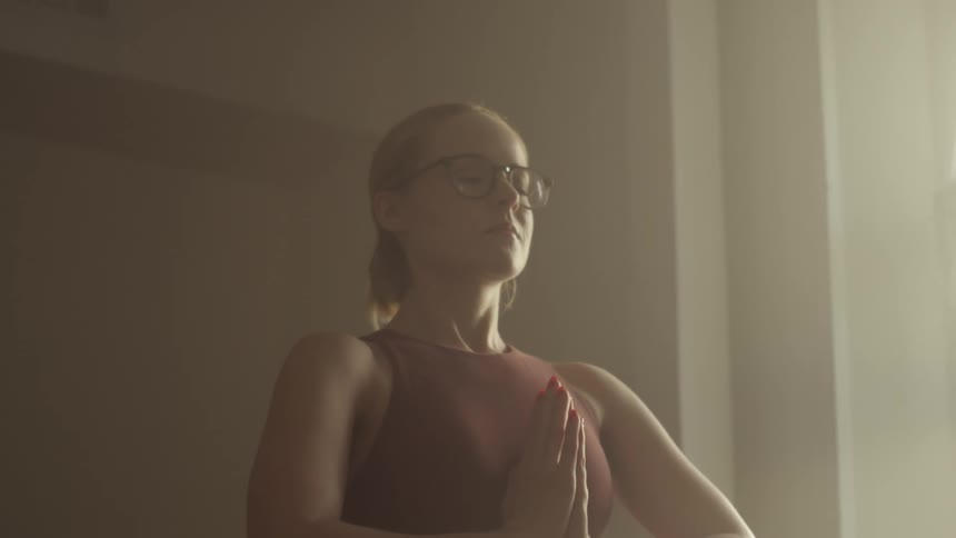 Young woman meditating in a room