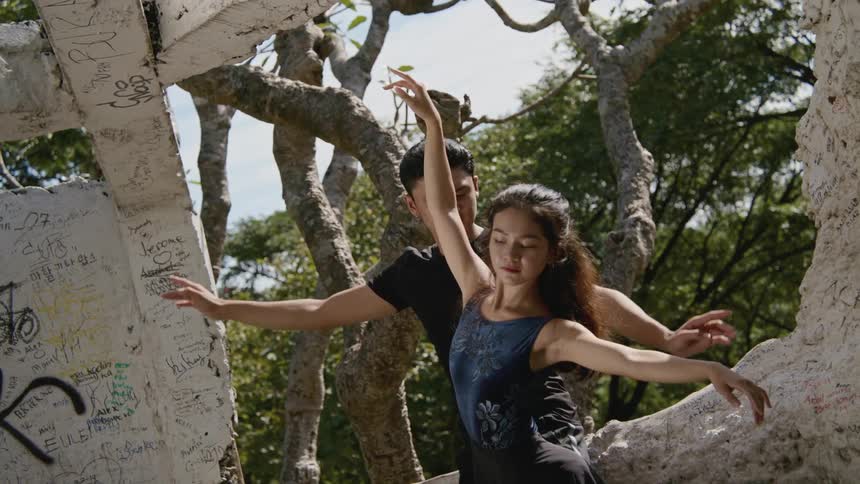 A male and female dancer practicing outside