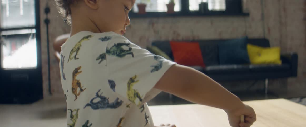 A kid that is coloring at a table