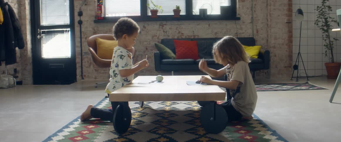Two boys play at a table in a home