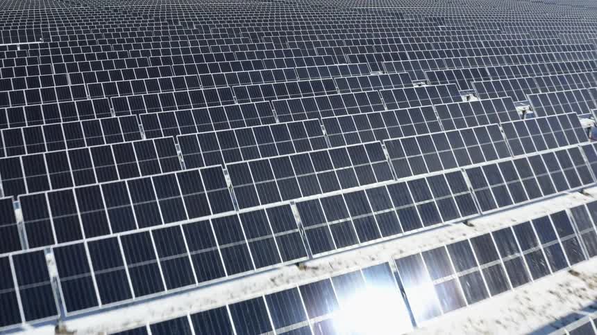 Sunlight reflecting on rows of solar panels outside