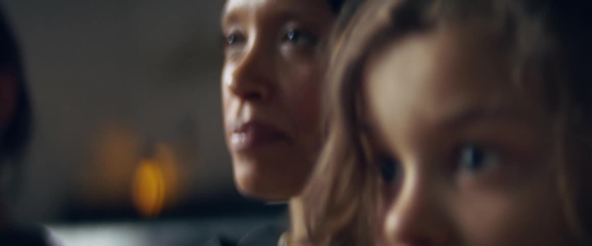 A family sits at home and watches television