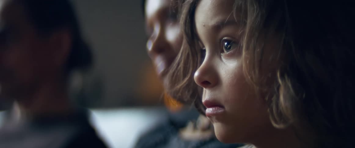 A child staring ahead while deep in thought