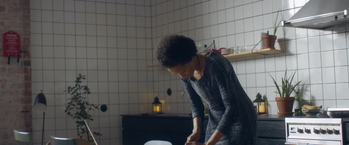 A woman dancing and cooking