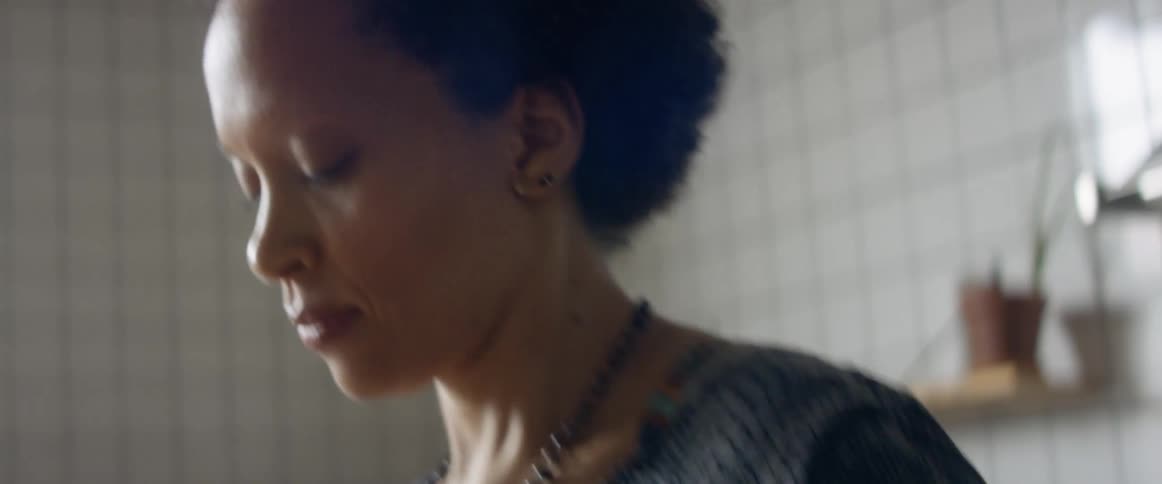 A woman dancing while standing inside a room
