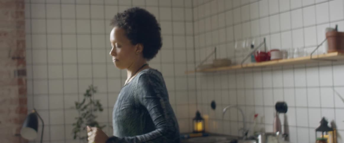 A woman dancing alone in a home kitchen