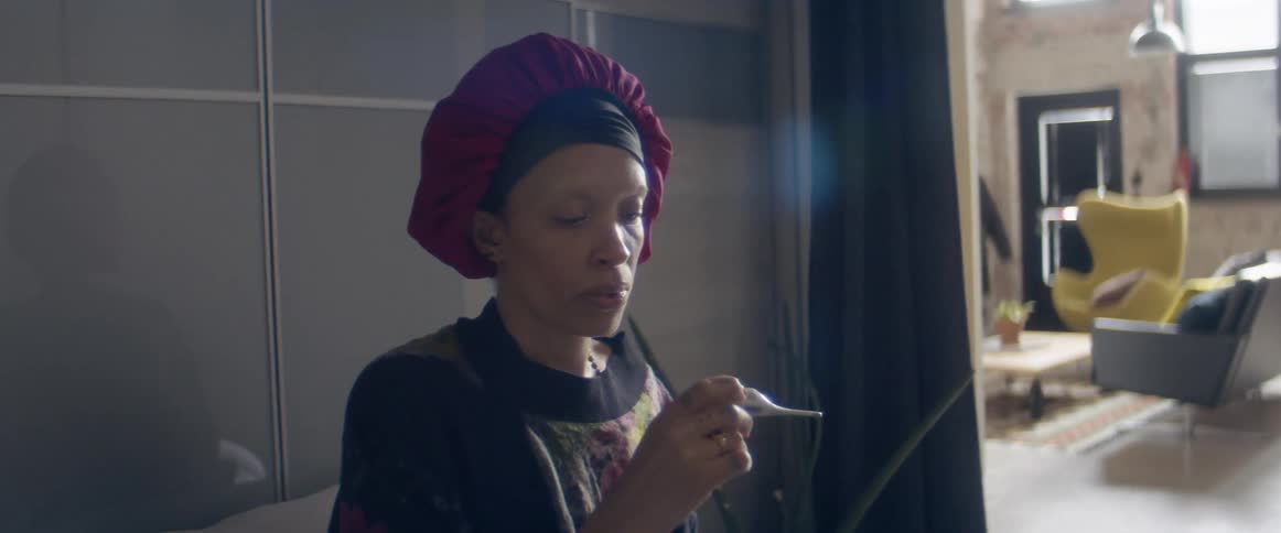 Woman lets out a sigh of relief after taking her temperature at home