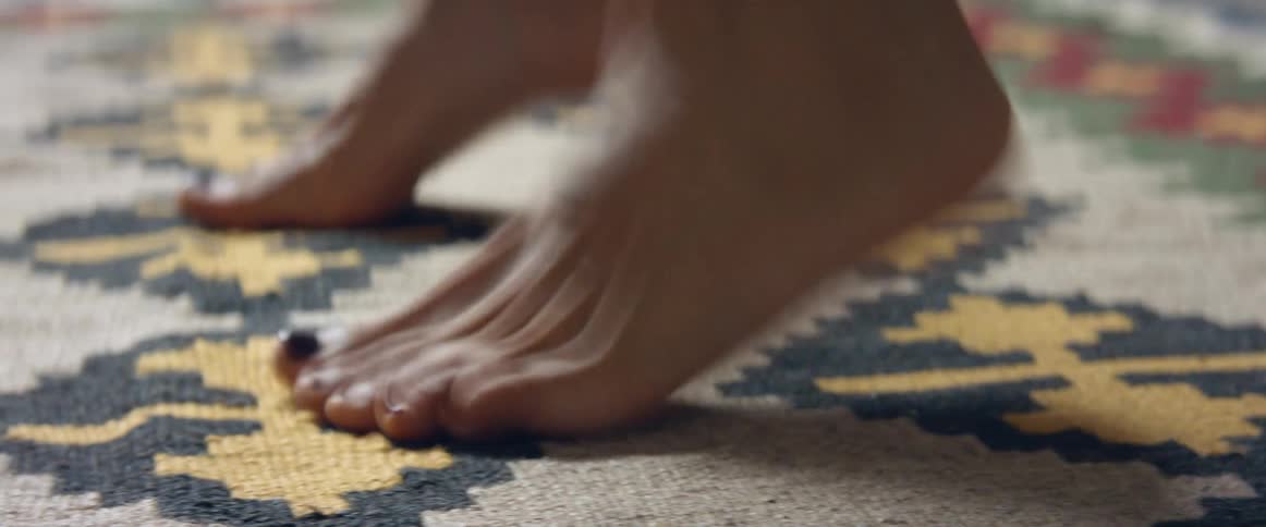 A woman runs in place on a rug