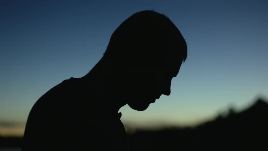 A portrait of a man standing outside
