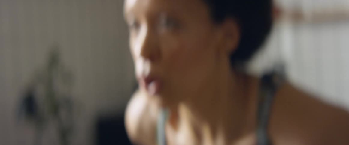Woman sweats and breathes deeply while working out