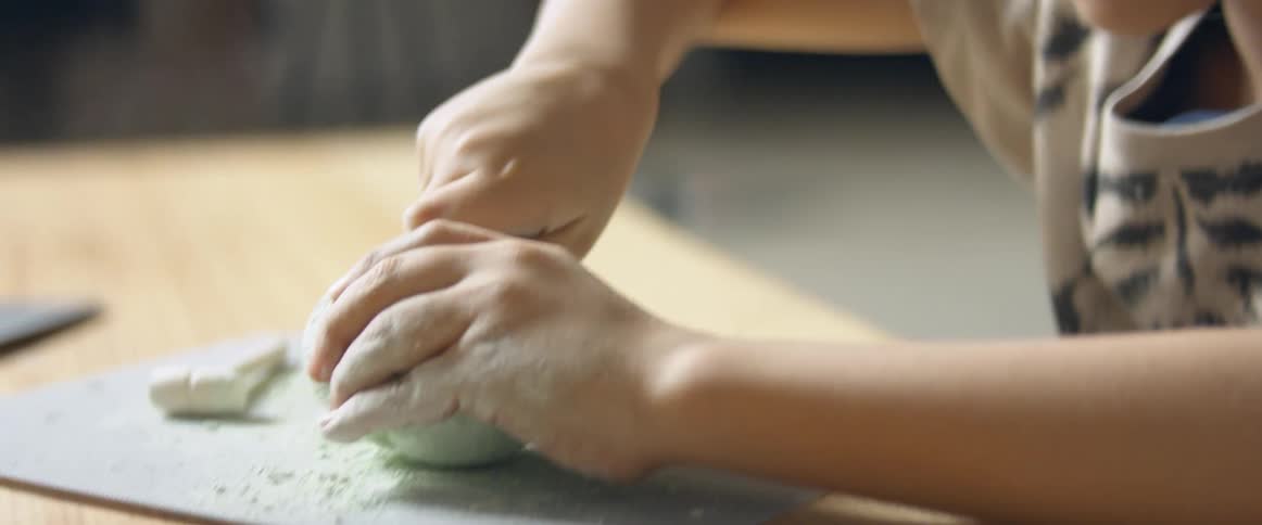 A child plays with clay at home