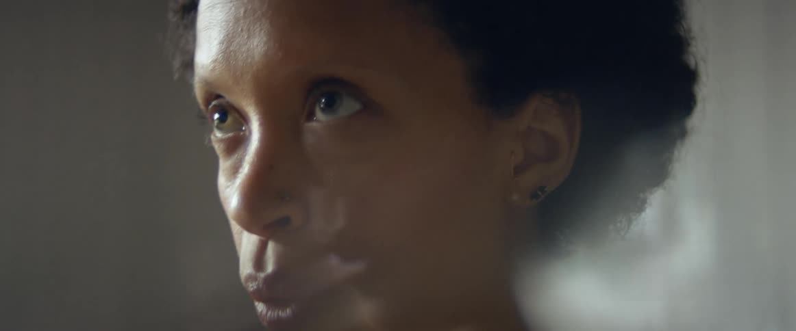 A woman takes a deep breath before running in place in her living room