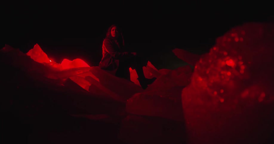 A woman sitting outside on rocks