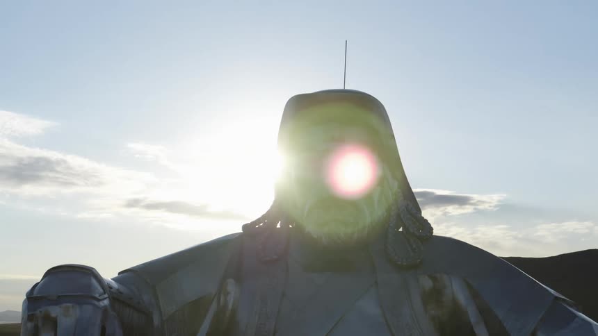 A statue with a landscape with a mountain range the sky and clouds in the background